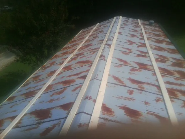 Rusted metal roof panels with new wood purlins before replacement — Storm Damage Roof Repair in Alachua by Roofing Brothers